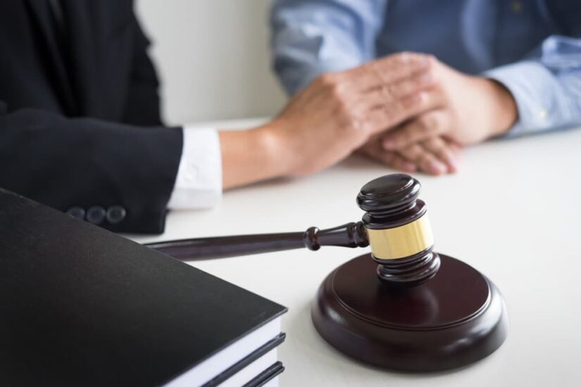 Judge gavel with lawyers advice legal at law firm in background. 