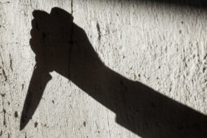 Photo of Shadow of a Person Holding Knife