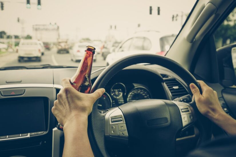 Person Driving With Beer In Hand