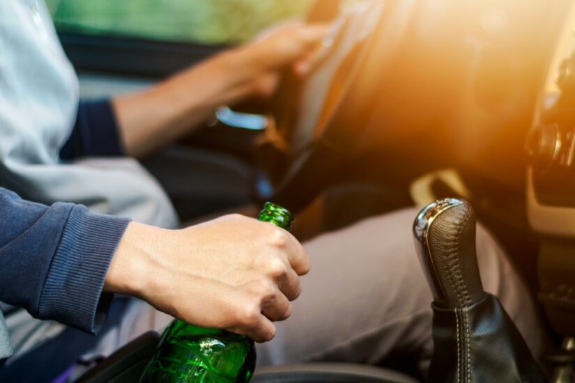 Person Driving While Holding Beer In Hand