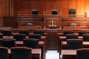 Red wooden table and red chair in court of law