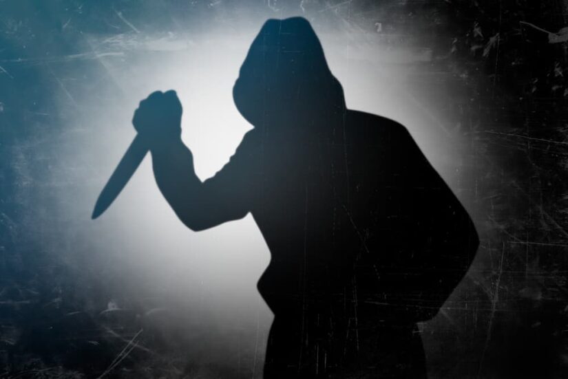 Shadow of the murderer holding the murder weapon knife in hand