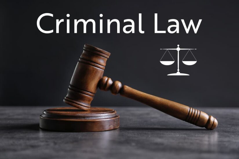 Judge's gavel on table against light background. Text CRIMINAL LAW