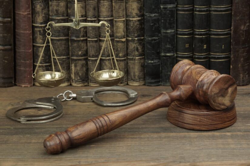 Judge Gavel, Law Book And Scale Of Justice In The Courtroom On Wooden Table