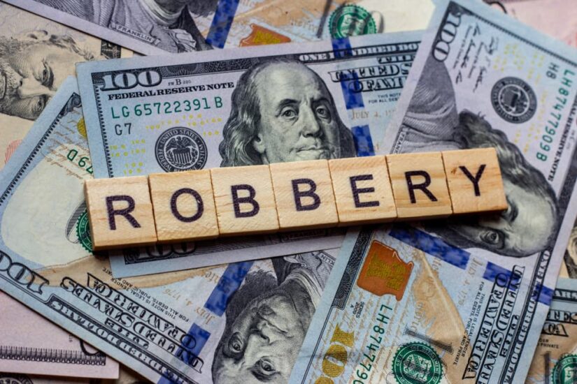 The word robbery on dollar USA background