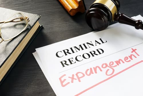 papers on desk titled criminal record with 'expungment' written on it